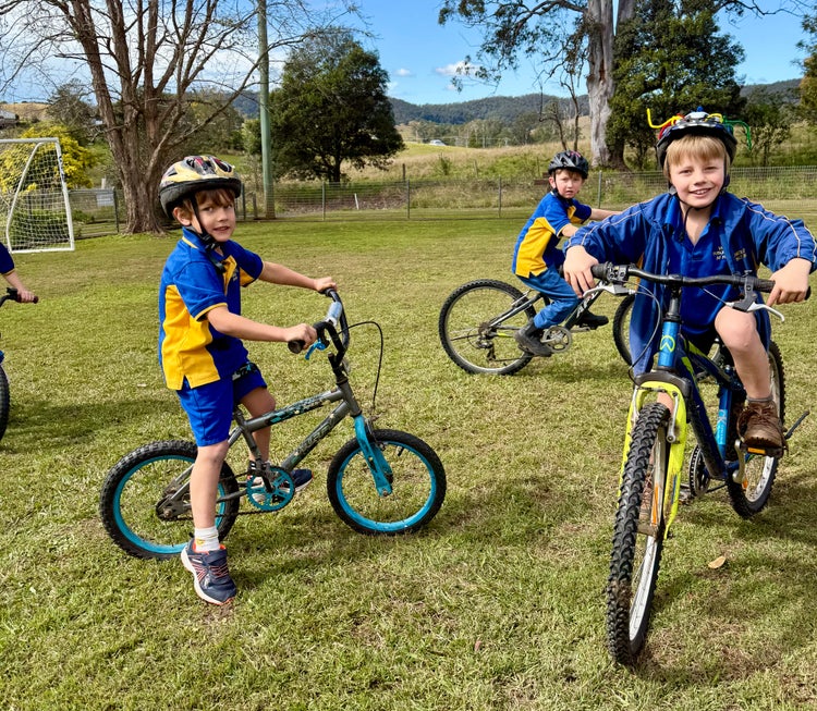 photo of three students riding bikes