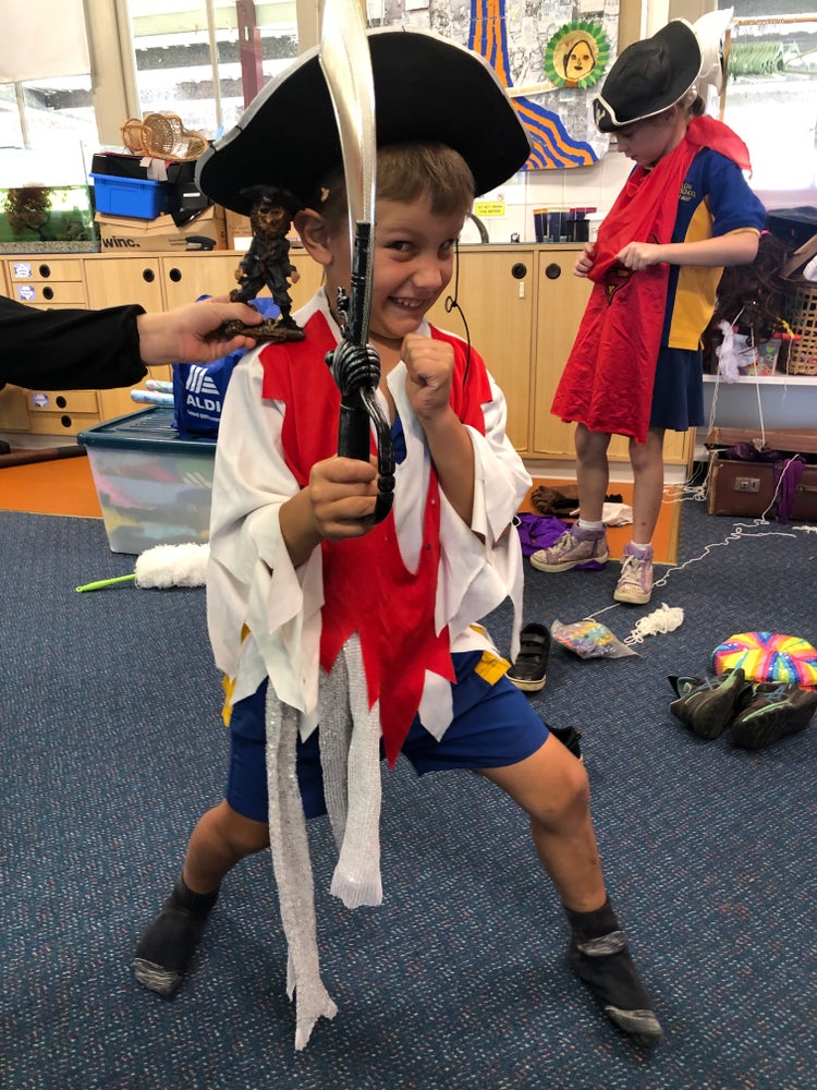 Photo of a student dressed up as a pirate and holding a sword