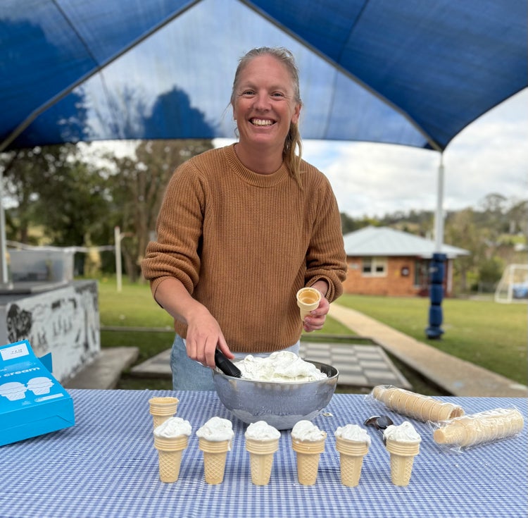 Photo of an adult serving ice cream in cones